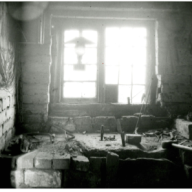 B+W image of the interioe of anAwl Blade maker's workshop Sandbank Bloxwich 1915. Tools, lamp stone block